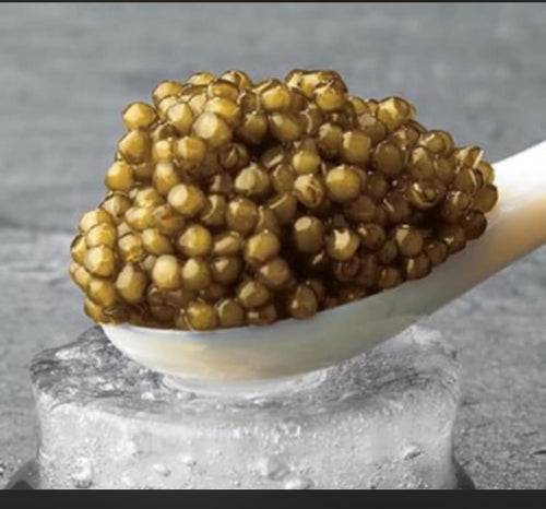 Caspian black caviar heaped on a mother-of-pearl spoon over ice