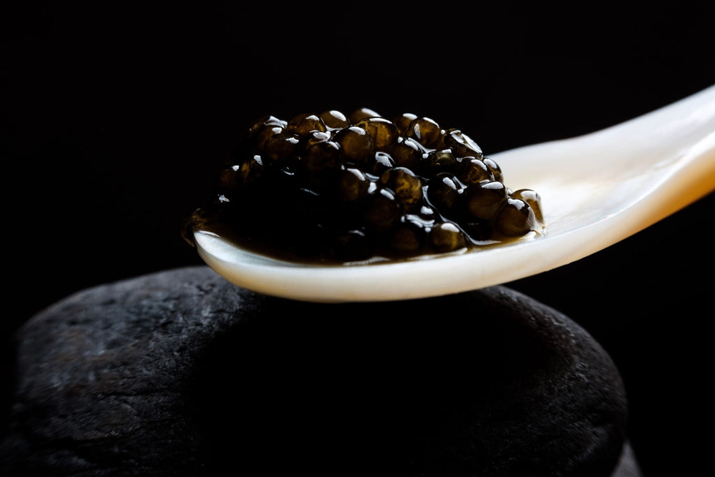 Black caviar served on a mother-of-pearl spoon